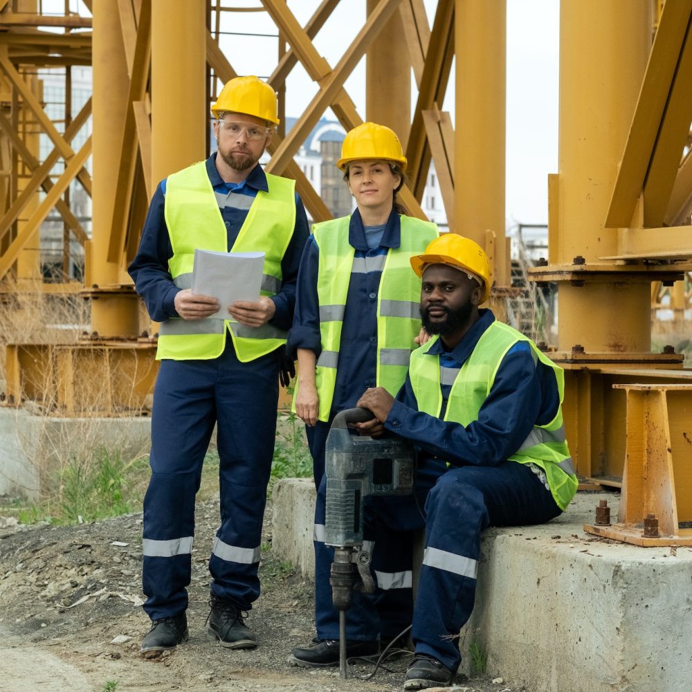 Group of young contemporary builders in workwear